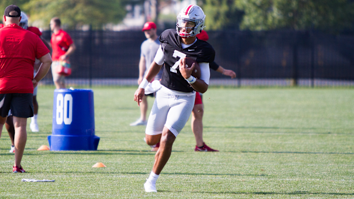 C.J. Stroud runs with the football during Ohio State training camp.